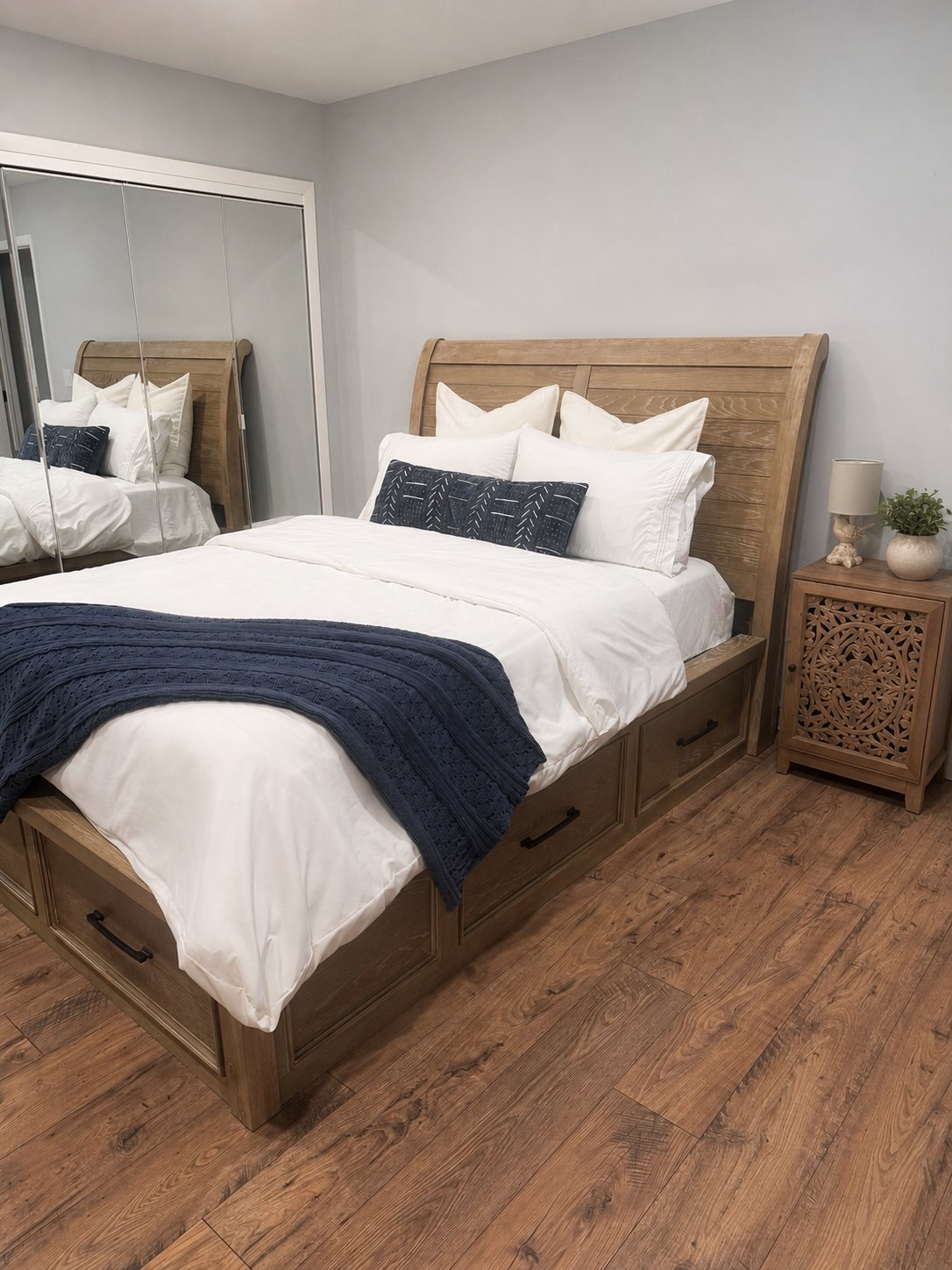 Queen bedroom made up with fresh white linens and a navy throw